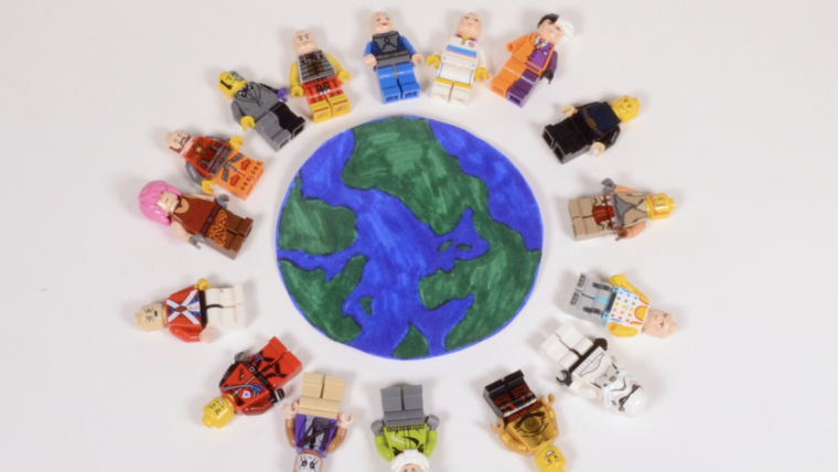 Lego figures circling a drawing of the earth