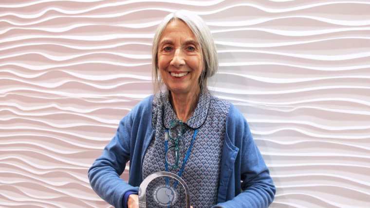 Emeritus Professor Irene Roberts holds the 2022 Ham-Wasserman Lecture Award from the American Society of Hematology.